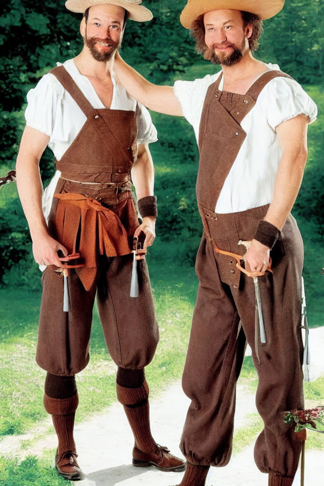 Traditional Bavarian men in suspenders and hats smiling outdoors