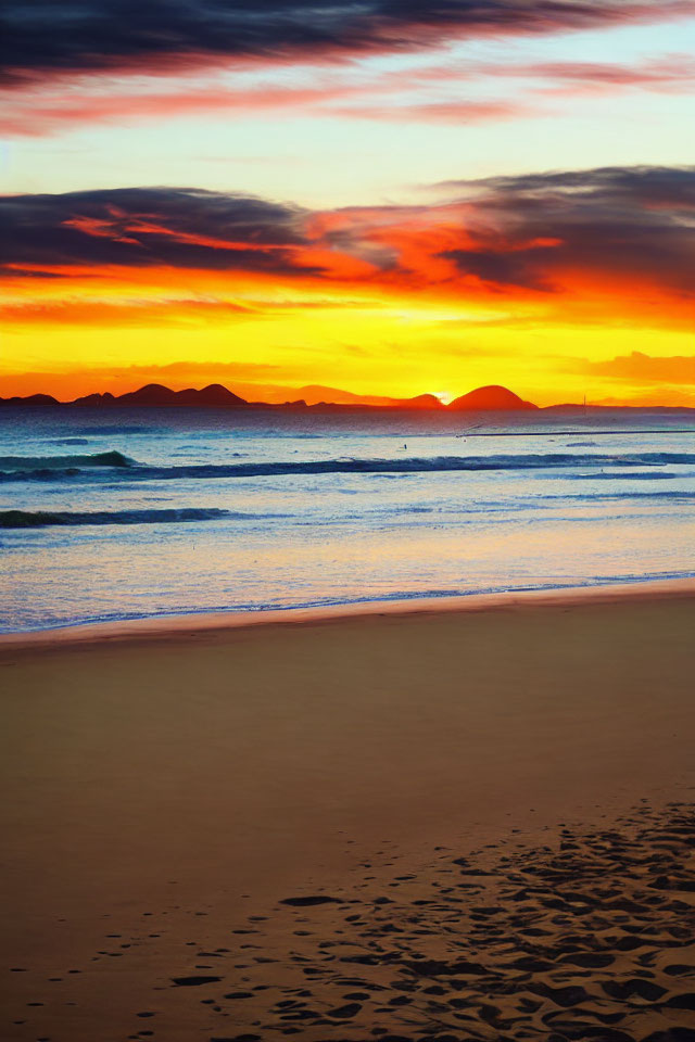 Scenic beach sunset with fiery clouds, tranquil waves, and sandy shores