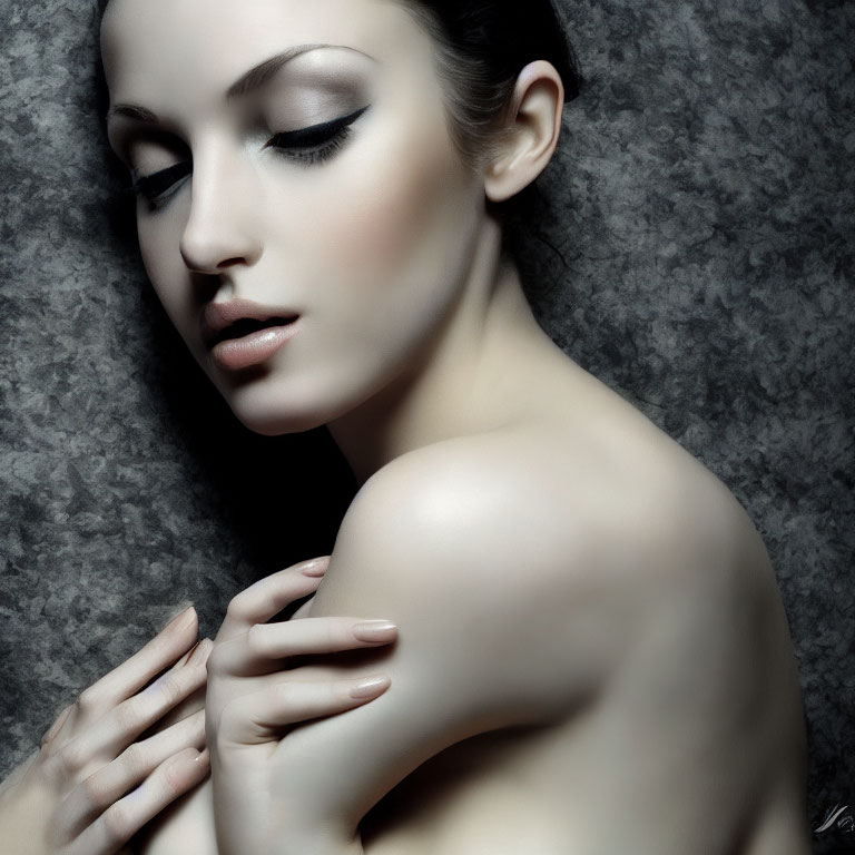 Serene expression with prominent makeup against textured backdrop