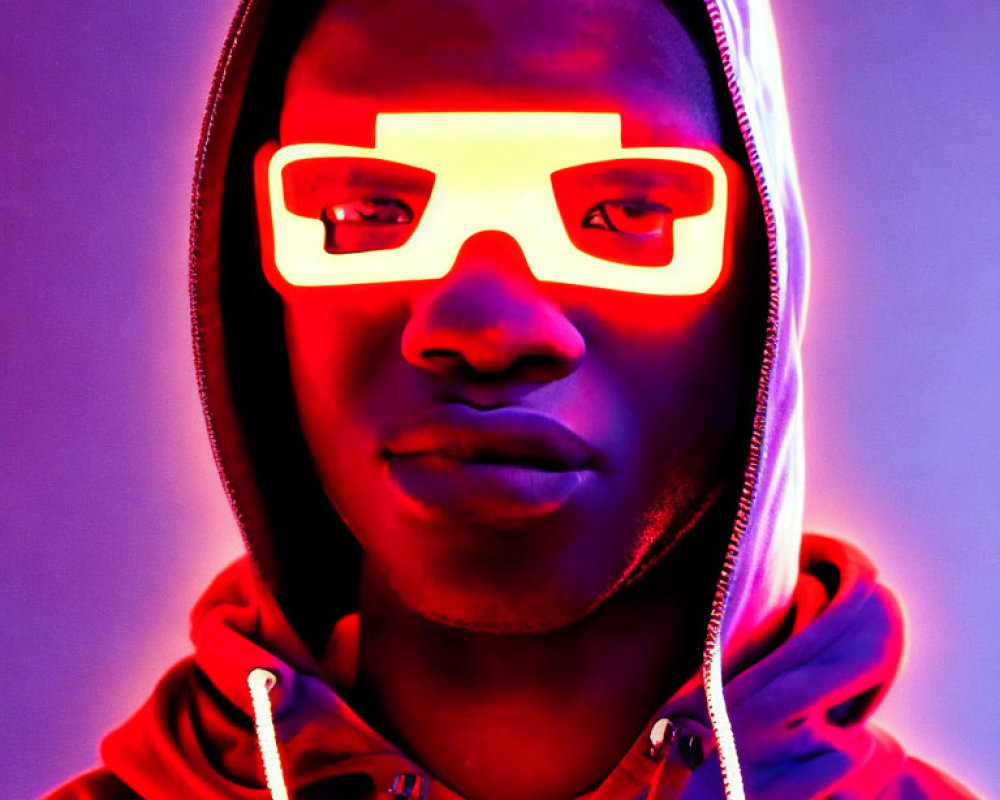 Person in Red Neon Glasses and Hoodie Against Blue and Purple Background