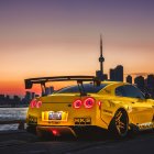 Yellow Sports Car Parked at Sunset with Historic Buildings in Background