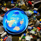 Illustration of Earth surrounded by discarded items symbolizing global waste issues