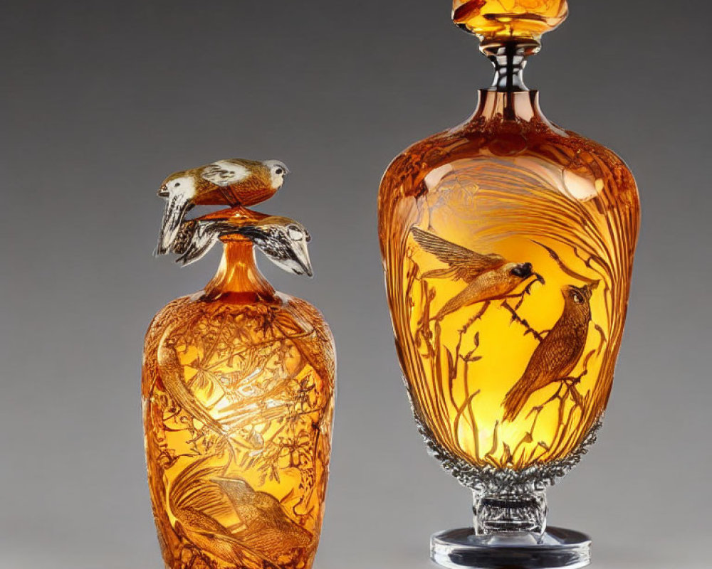 Ornate amber glass vases with bird and nature engravings