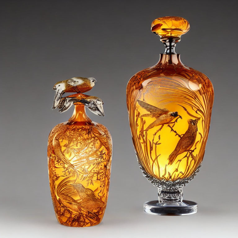 Ornate amber glass vases with bird and nature engravings