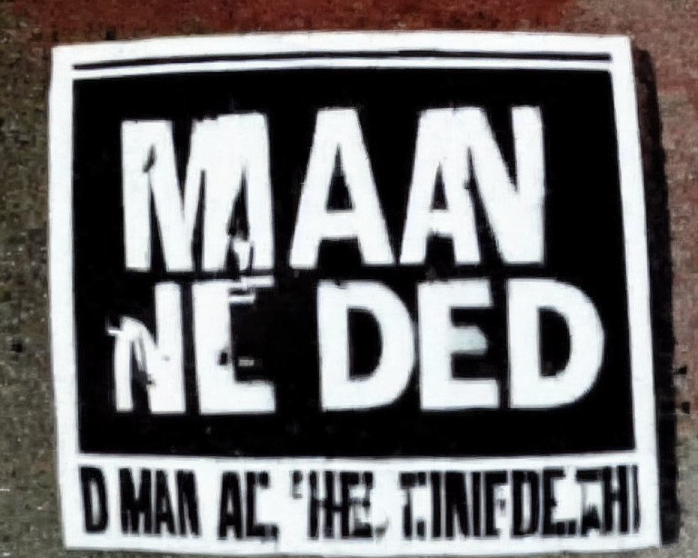 Monochrome ground sticker with bold, partially obscured text.