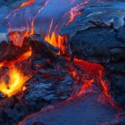 Volcanic landscape with lava rivers, glowing magma, and robed figure.
