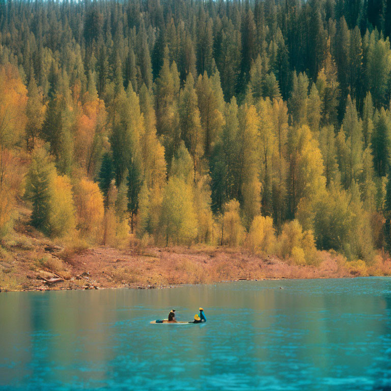 Kayaking on Turquoise Lake Amid Autumn Trees and Forested Hill