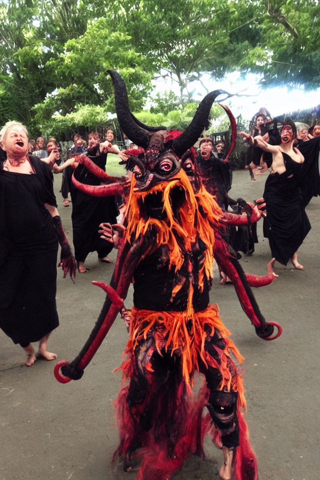 Elaborate Red and Black Demonic Costume Leading Frenzied Group