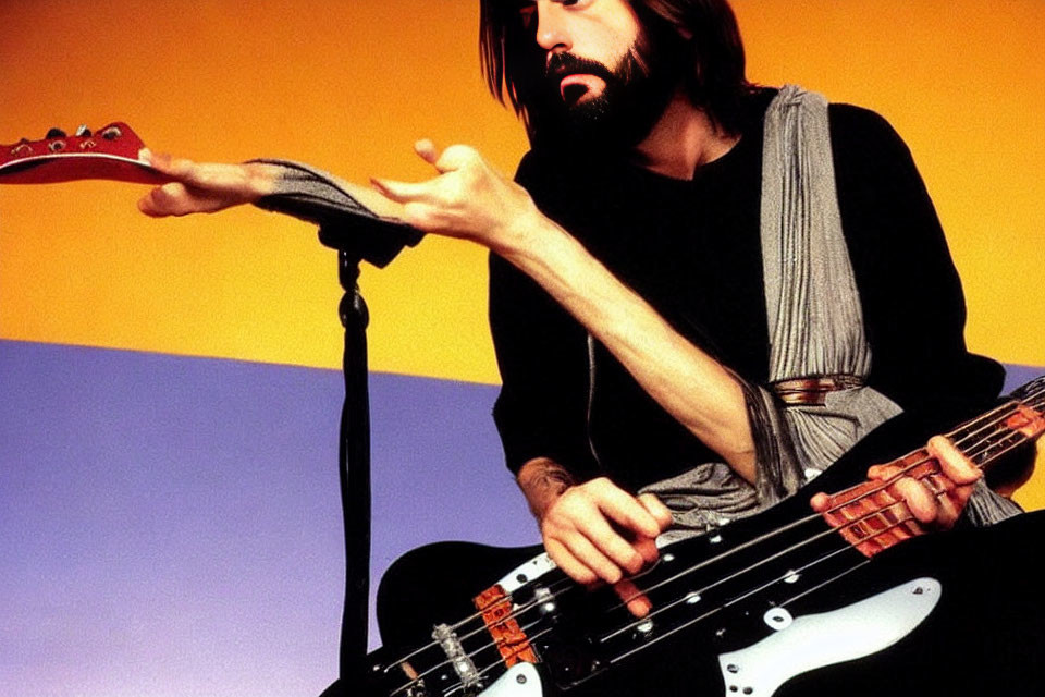 Bearded Musician with Electric Bass Guitar on Colorful Background