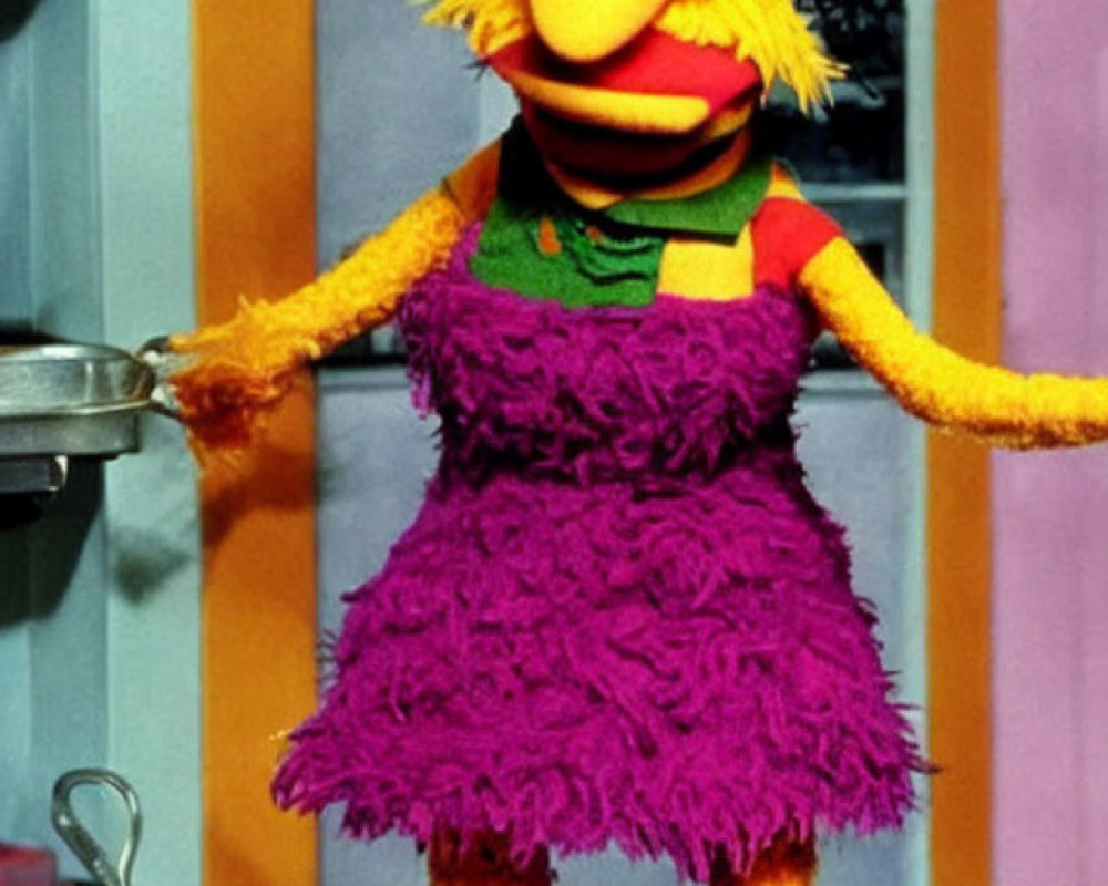 Colorful Puppet in Purple Dress with Frying Pan in Kitchen