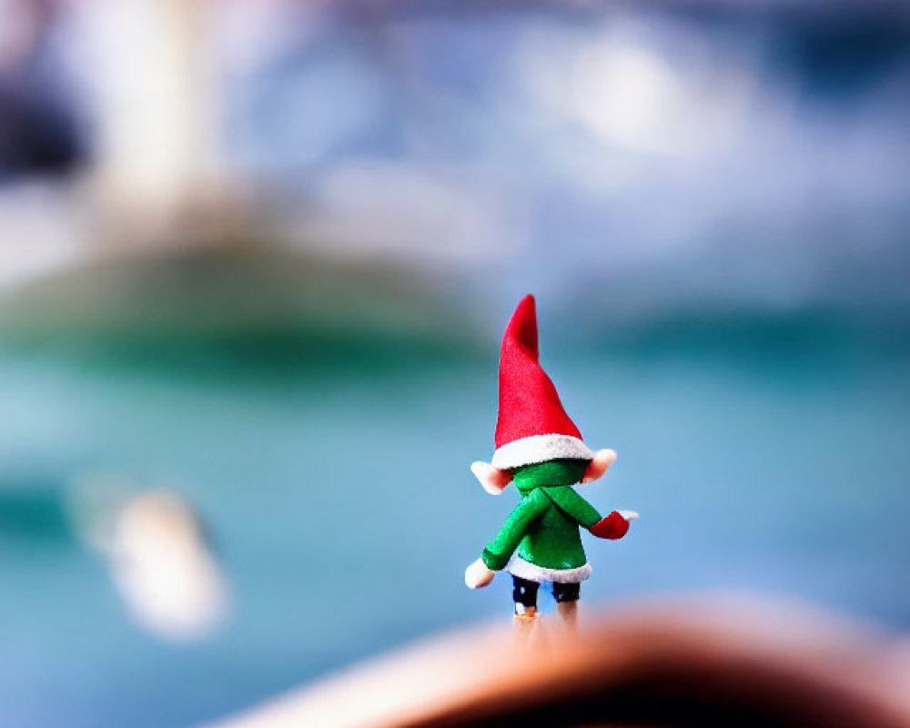 Small Gnome Figurine on Wooden Boat with Blurred Water Background