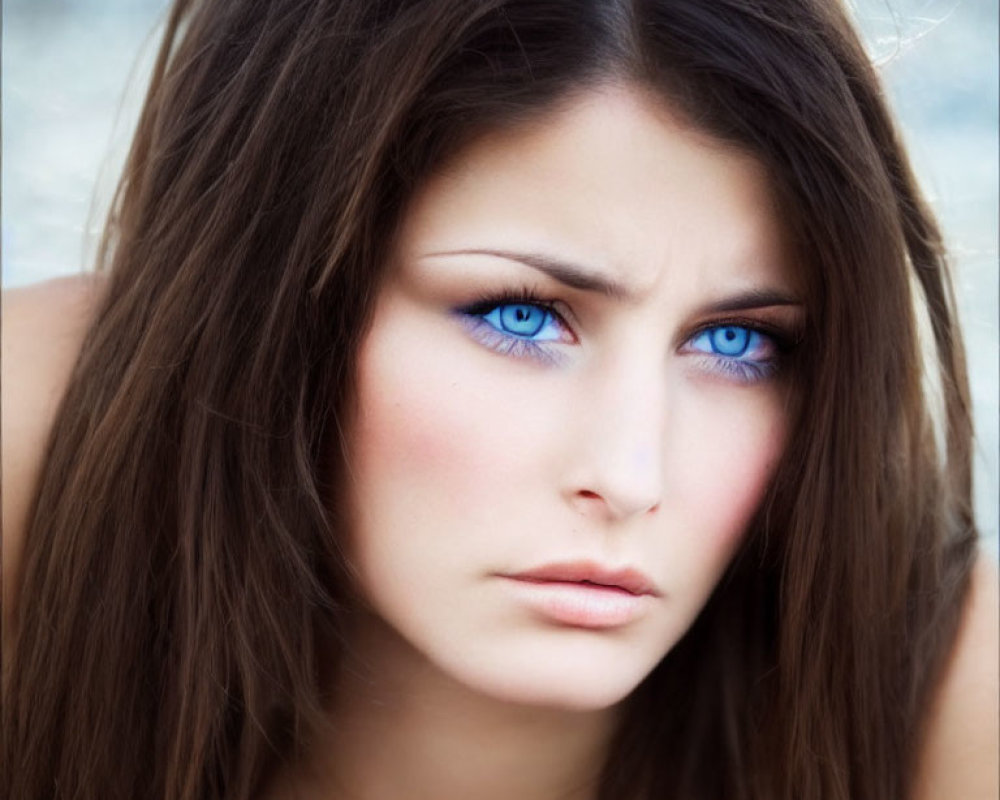 Close-Up of Woman with Striking Blue Eyes and Long Brown Hair
