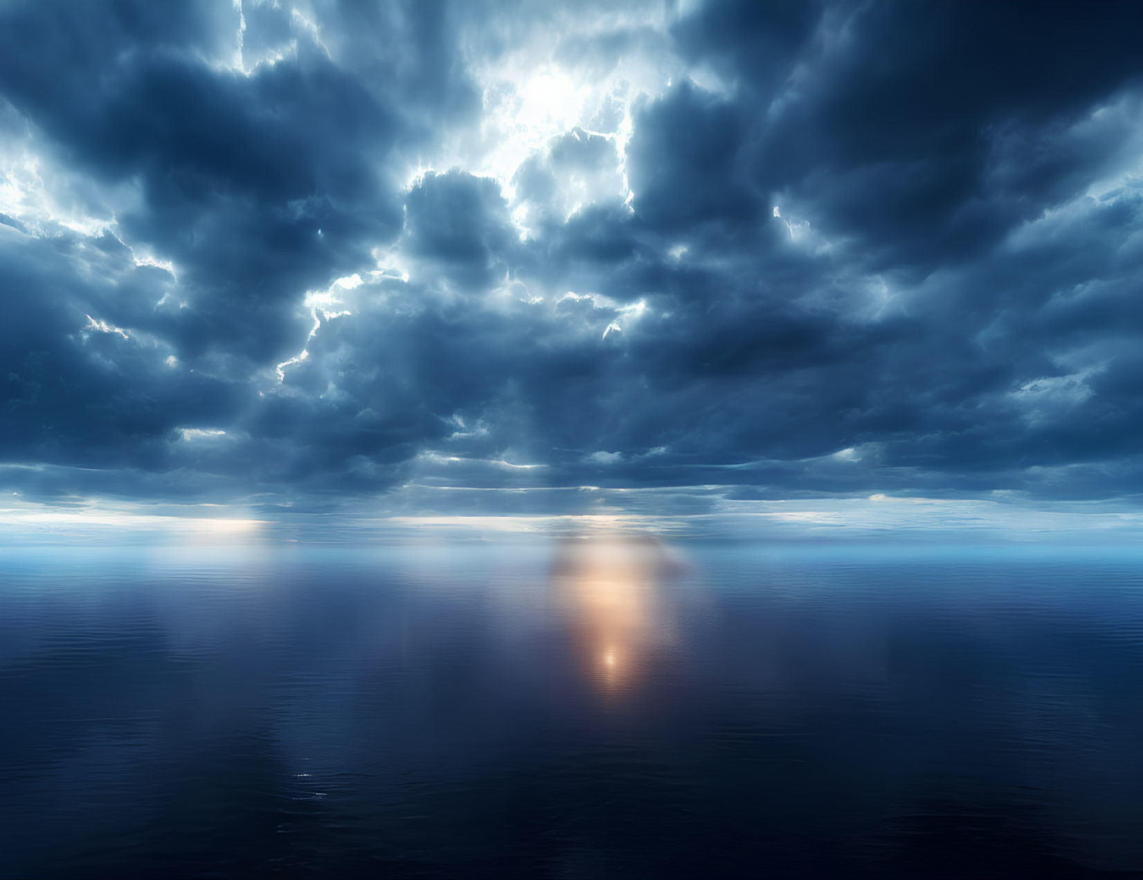 Dramatic seascape with dark clouds and sunlight reflection