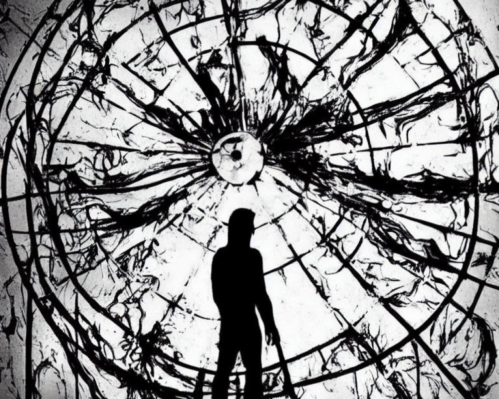 Silhouette of person in front of shattered circular window