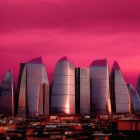 Futuristic crystal-like buildings in dramatic urban landscape under crimson sky
