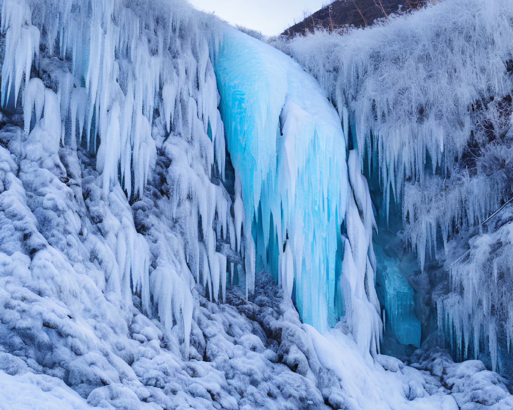 Frozen Waterfall with Blue and White Ice Formations Amid Frosty Vegetation