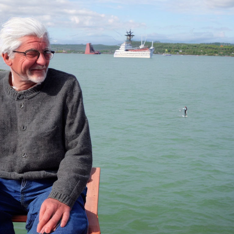 Elderly man smiling by water with cruise ship and seagull