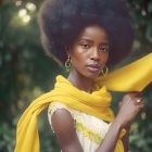 Woman with Afro in Yellow Scarf and Earrings on Green Background