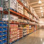 Warehouse Store with High Shelving and Shoppers browsing Aisles
