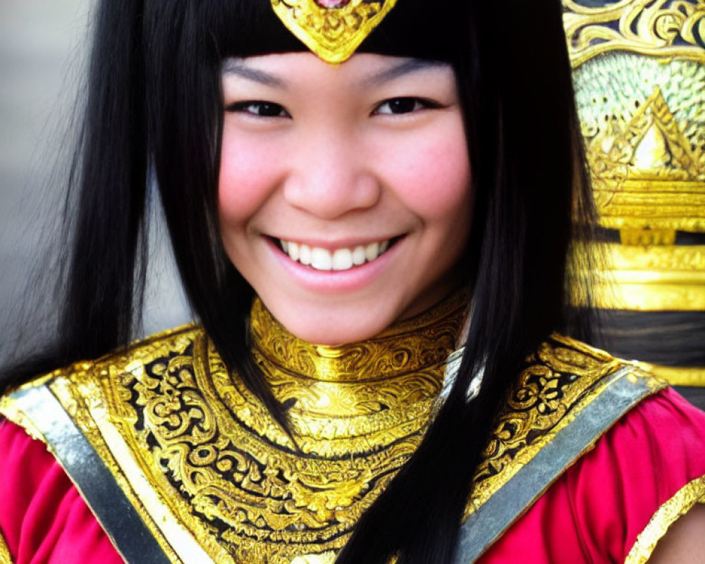 Traditional Thai Attire with Ornate Gold Patterns and Gem Headpiece