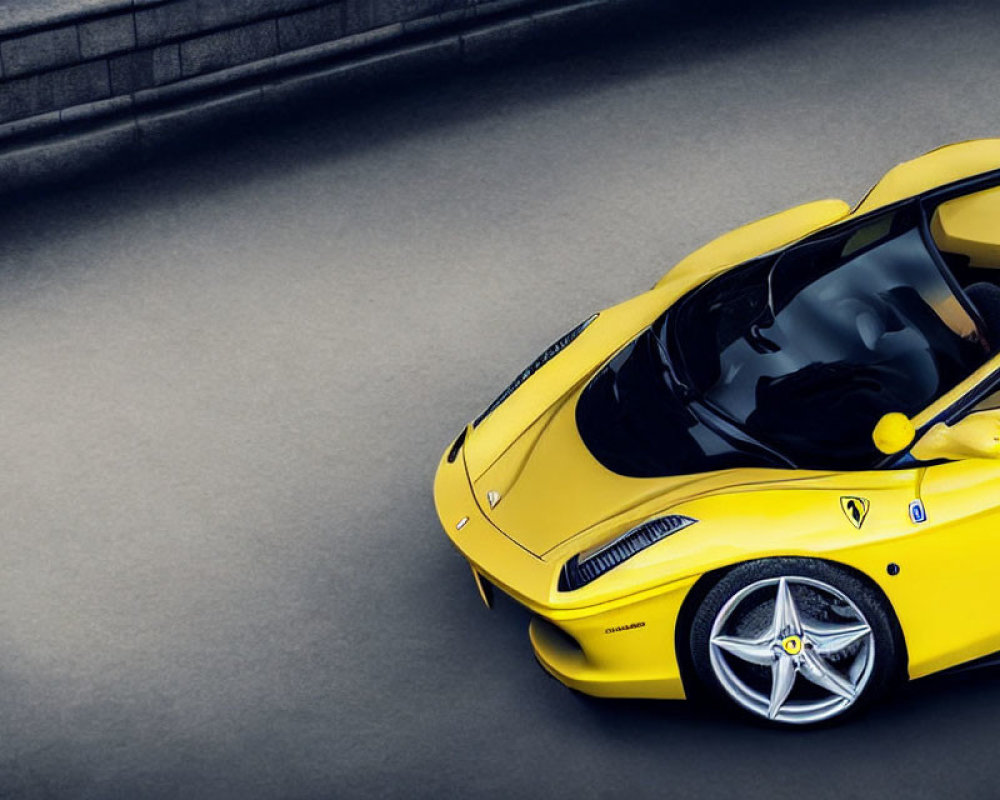 Yellow Sports Car with Aerodynamic Design and Iconic Emblem on Grey Asphalt