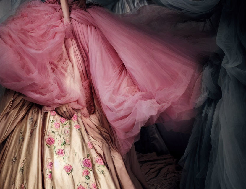 Elegant Pink Gown with Tulle Overlay and Floral Skirt in Romantic Setting