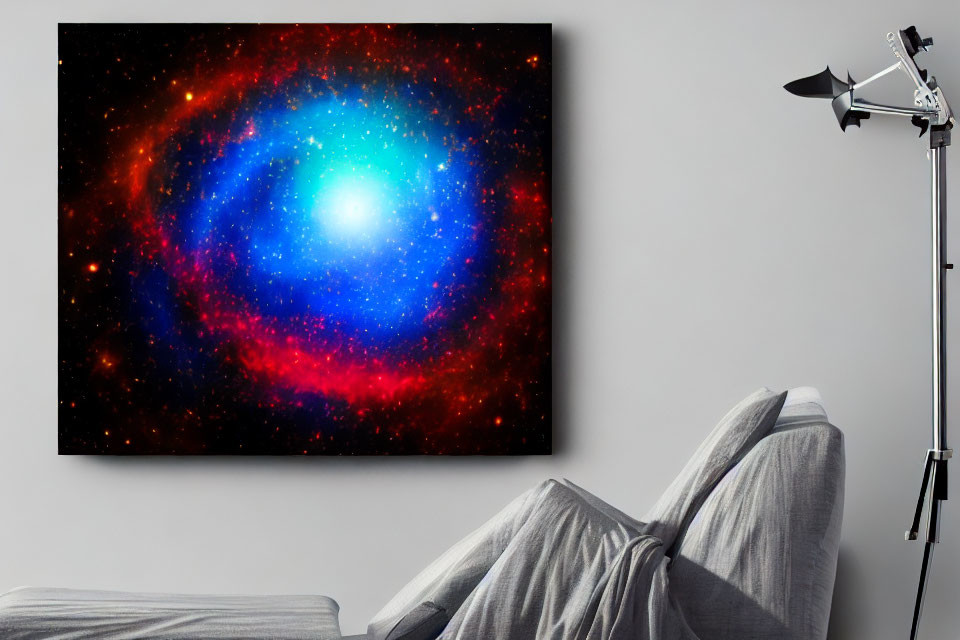 Colorful space-themed canvas above grey sofa with person's legs.