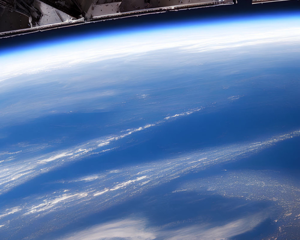 Earth from space with spacecraft segment and curved horizon.