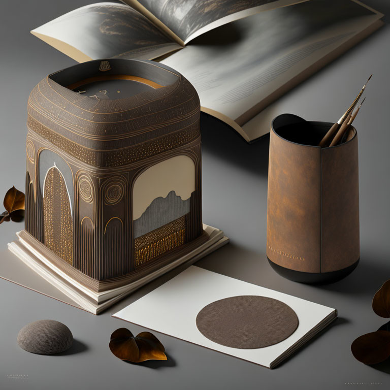 Vintage-inspired desktop setup with ornate pencil holder, leather cup, open book, and art supplies on