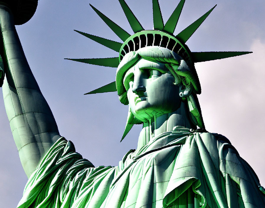 Statue of Liberty Close-Up with Crown, Torch, and Robe Against Blue Sky