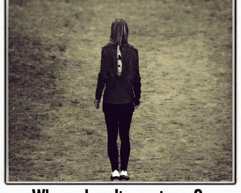 Long-haired person in field with overlay text.