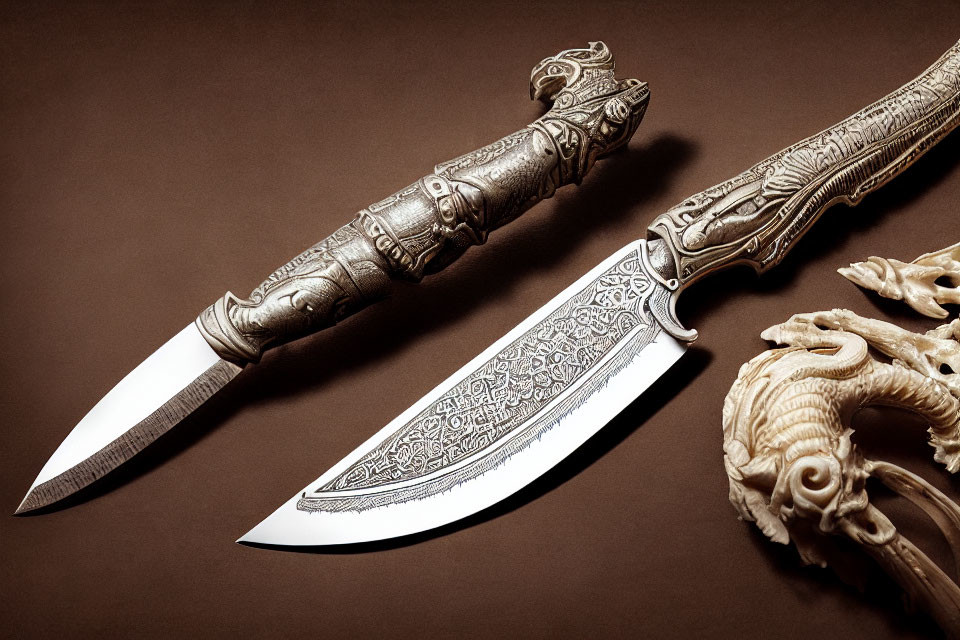 Intricately carved knives with detailed designs on blades and handles
