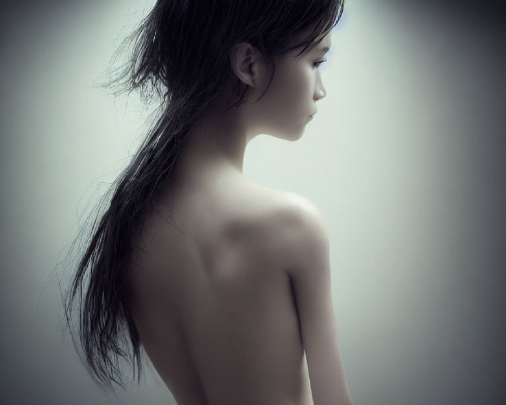 Monochrome photo of woman's side profile with bare shoulders and long hair