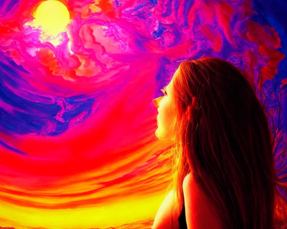 Woman gazing at vibrant sunset with red, orange, and purple clouds.