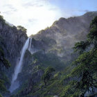 Majestic waterfall in serene landscape with lush greenery