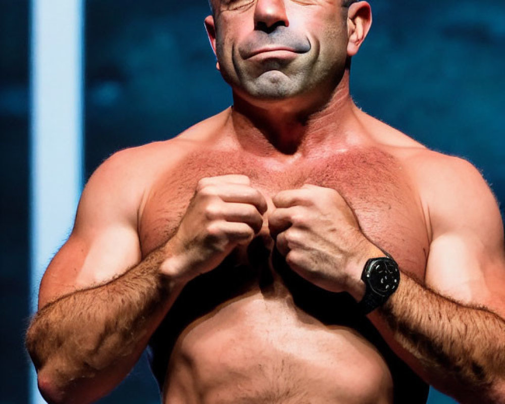 Muscular Bald Man Flexing Chest on Stage with Blue-lit Background