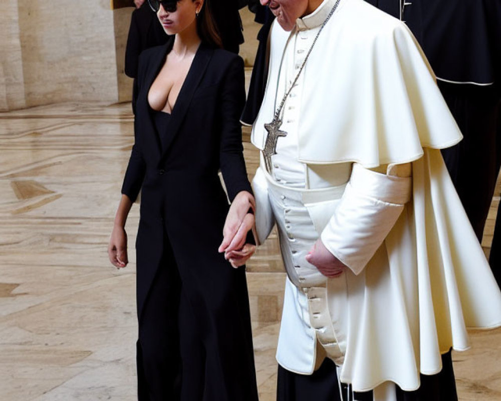 Woman in black suit with smiling man in white papal attire and two men in ecclesiastical