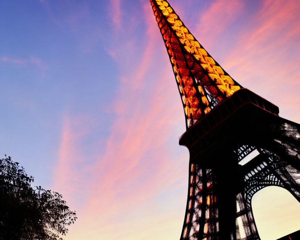 Iconic Eiffel Tower at dusk with vibrant pink and blue sky