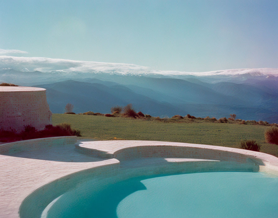 Curved Edge Infinity Pool with Mountain View