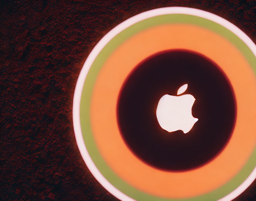 Concentric Circles Surround Glowing Apple Logo on Dark Textured Background
