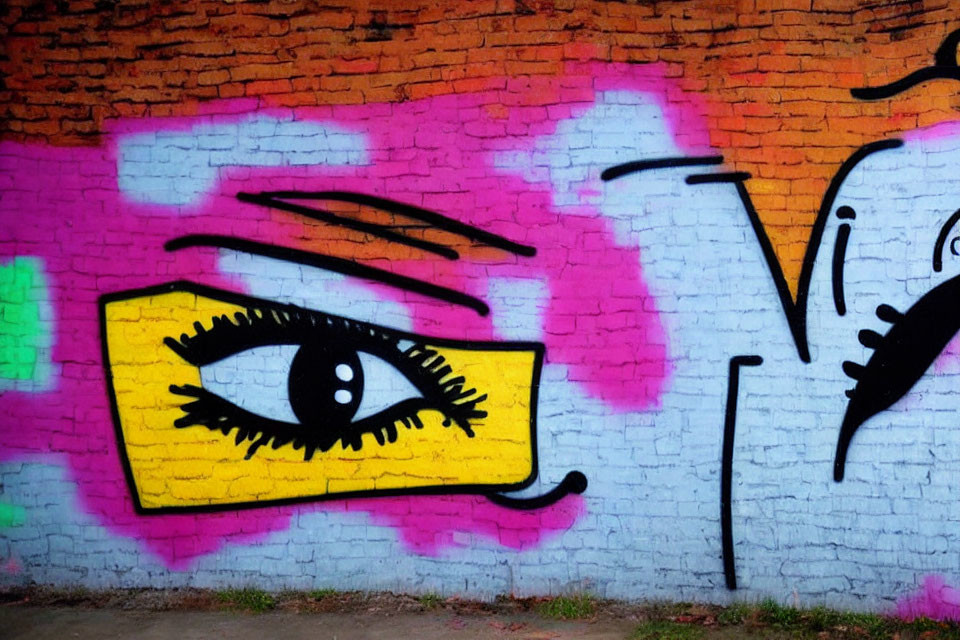 Vibrant eye graffiti with pink and yellow colors on brick wall