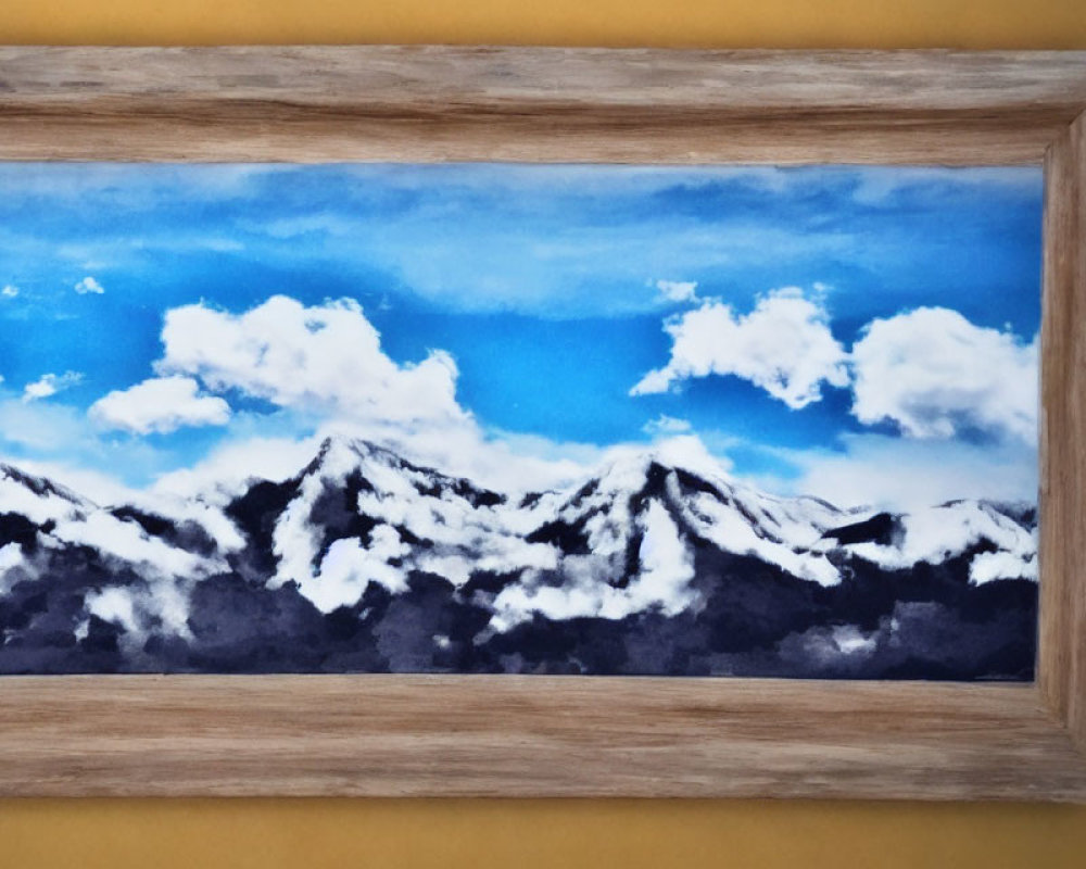 Snow-capped mountains under blue sky and clouds in wooden frame on yellow background