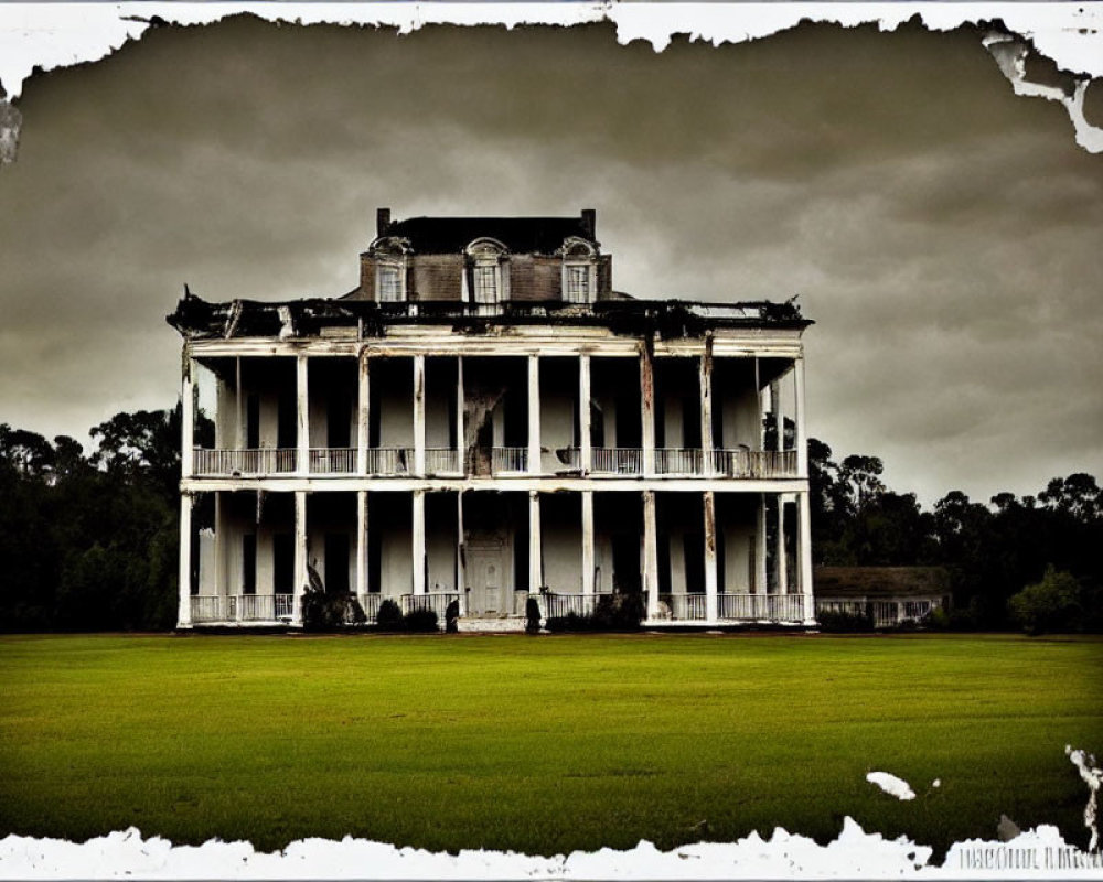 Vintage-style photograph of old two-story house with columns against overcast sky and lush green field