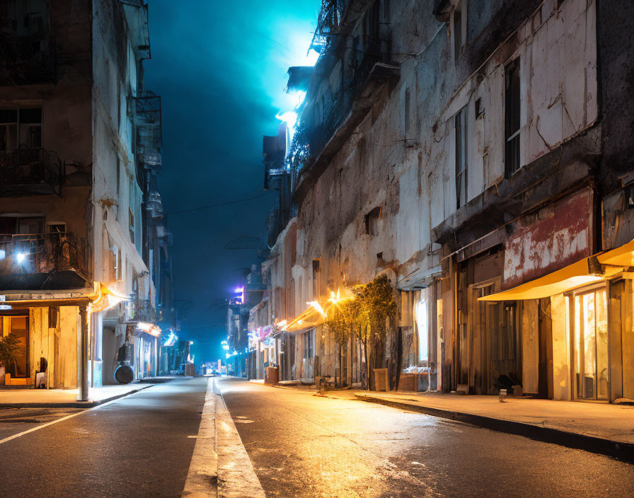 Deserted urban street at night with streetlights and neon glow