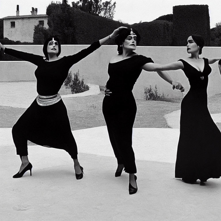 Three Women Performing Synchronized Dance Outdoors