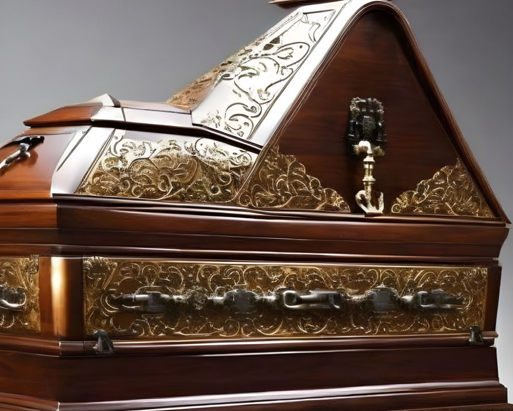 Wooden coffin with intricate metal detailing on gray background