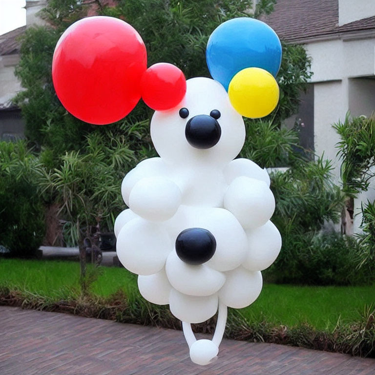 White Dog Balloon Sculpture with Colorful Balloons in Residential Setting
