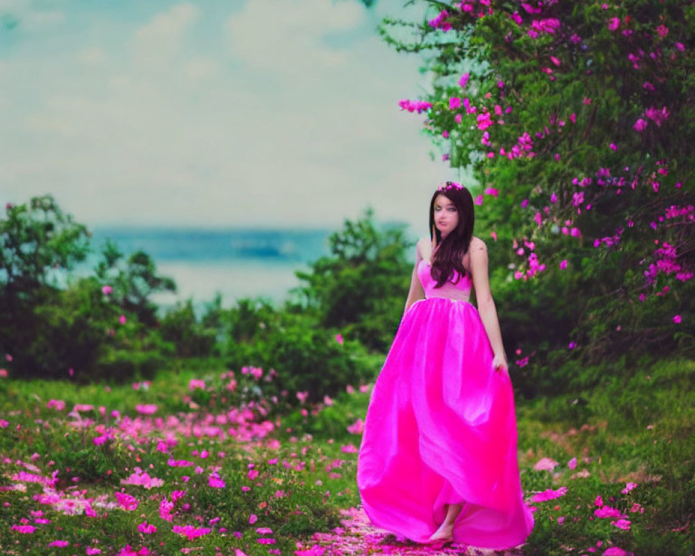 Young woman in pink dress surrounded by greenery and flowers near blue lake