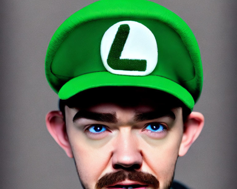 Exaggerated-eyed person in green cap with letter "L" like Mario character.