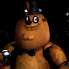 Close-up of Freddy Fazbear animatronic with top hat and bowtie on dark background.